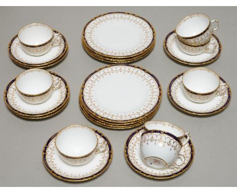 A SET OF EIGHT ROYAL CROWN DERBY COBALT AND GILT TEA CUPS, SAUCERS AND SIDE PLATES, 1900, WITH LIGHTLY MOULDED BORDER, PLATE 