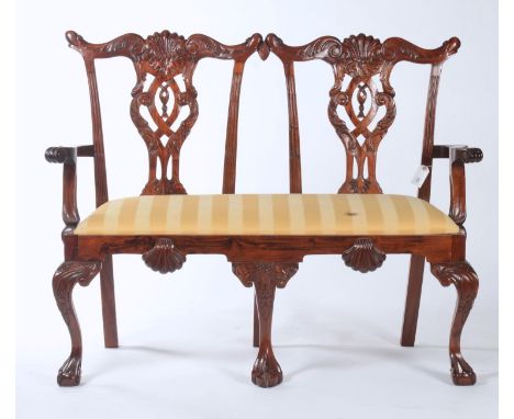 A REPRODUCTION MAHOGANY CHAIR BACK SOFA IN GEORGE III STYLE, THE TWIN BACK WITH LEAF AND SHELL CARVED CRESTING RAIL ABOVE A P