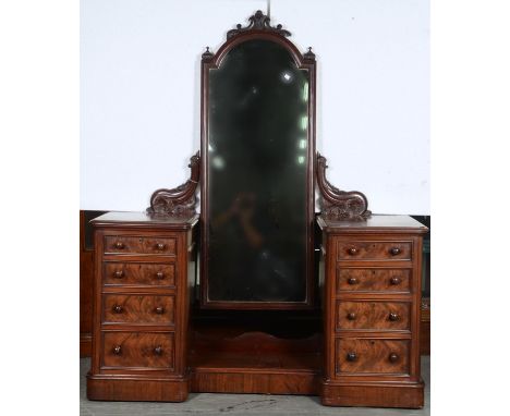 A VICTORIAN MAHOGANY DRESSING TABLE, THE ARCHED MIRROR PLATE WITHIN MOULDED FRAME SUPPORTED ON A PAIR OF LEAF AND FLOWERHEAD 