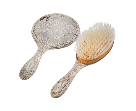 A SILVER HAND MIRROR AND HAIRBRUSH, DIE STAMPED WITH CHERUB'S HEADS, EARLY 20TH C AND LATER, MARKS OBSCURED  Light wear but n