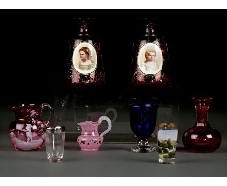 A PAIR OF BOHEMIAN OVERLAY GLASS SCENT BOTTLES, C1870, OF MALLET SHAPE IN RUBY GLASS OVERLAID IN WHITE AND PAINTED WITH CHILD