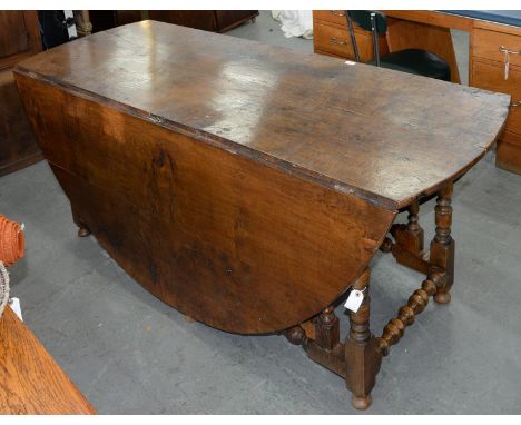 AN OAK DOUBLE GATELEG TABLE, 20TH C, IN CHARLES II STYLE, WITH BALUSTER AND BOBBIN TURNED UNDERFRAME, 75CM H; 187 X 207CM  Go