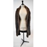 A brown full length fur coat, size 38.