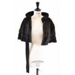 LOUIS VUITTON; a brown sheepskin fur cape, size small.
