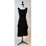 ALEXANDER MCQUEEN; a black silk lace short sleeves cocktail dress, size small.