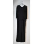 ELIE SAAB; a black jumpsuit with black lace trim, size 38. Condition Report: One sleeve slightly