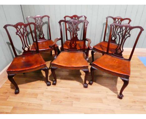 A set of six Edwardian Chippendale revival dining chairs, with vase splat and with overstuffed seats, on cabriole legs to bal