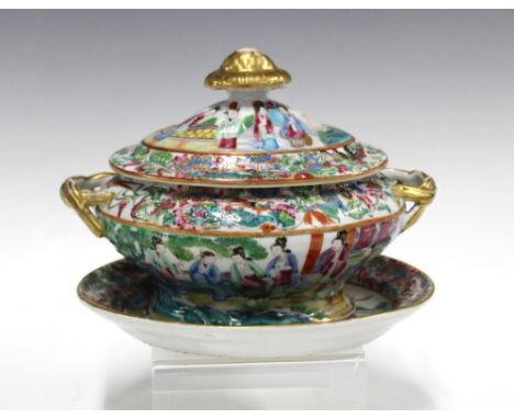 A 19th century Chinese canton enamel famille rose tureen with cover and oval stand, the cover with a gilded finial and side h
