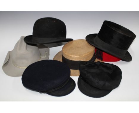 Vintage hat box containing a collection of felt caps and hats to include a bowler and top hat, etc together with a cloth cap 