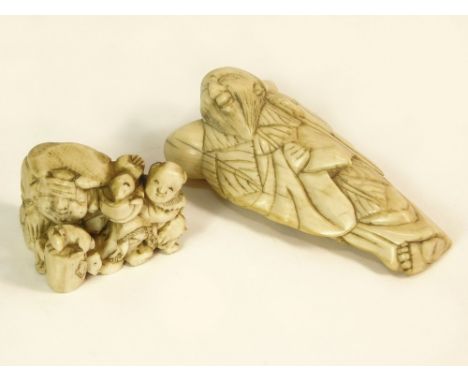 IVORY NETSUKE. Two 19th century ivory netsuke, one in the form of a traveller, height 6.5cm, the other a small group with an 