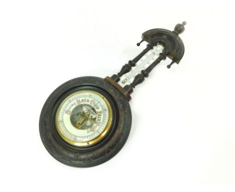 BAROMETER. A barometer/thermometer in carved wooden case. Height 51cm. WE CANNOT SHIP THIS LOT due to fragility, size or weig