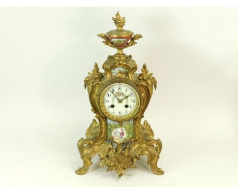 FRENCH MANTEL CLOCK. An early 20th century ormolu mounted mantel clock by AD Mougin, Paris. The case with decorative ceramic 