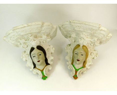 WALL BRACKETS. Two painted plaster moulded figurehead wall brackets. Max. width of bracket 29cm. Height 32cm.WE CANNOT SHIP T