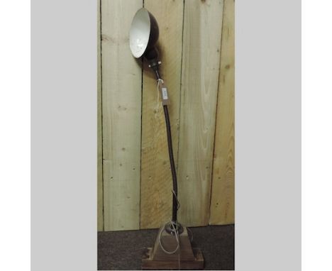A mid 20th century copper machinist's lamp, on a wooden base
