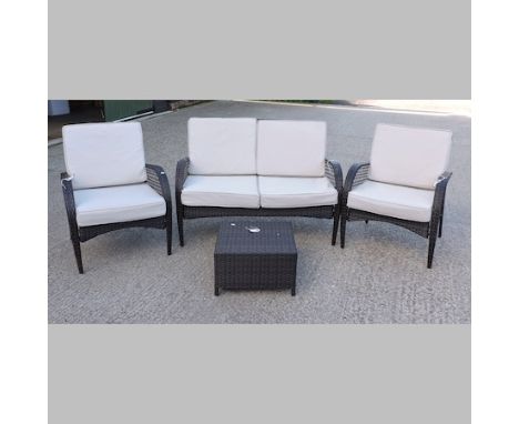 A rattan patio suite, comprising a sofa, 125cm, two armchairs, with loose cushions and a table