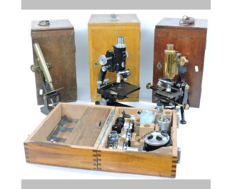 A microscope, by W. Watson and Sons Ltd, together with two others and microscope accessories, boxed, largest 35cm tall