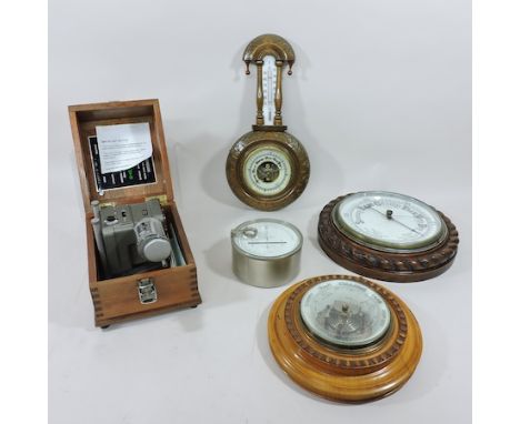 A 20th century aneroid barometer, by Mechanisms Ltd, Croydon, in a fitted wooden case, together with four others