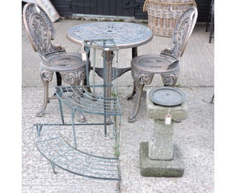 A patio set, comprising a circular table, 68cm diameter, and two chairs, together with a stone sundial and a metal plant rack