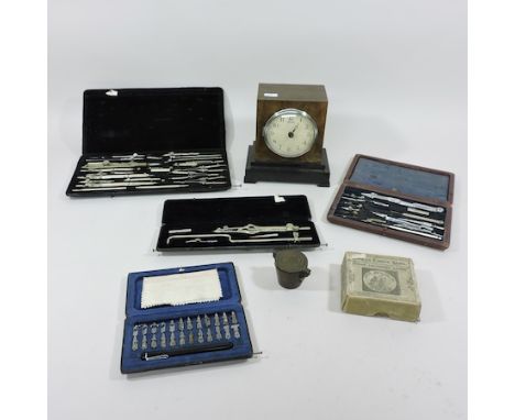 A collection of early 20th century draughtsman sets, together with a nesting weight set, a set of coloured lantern slides and