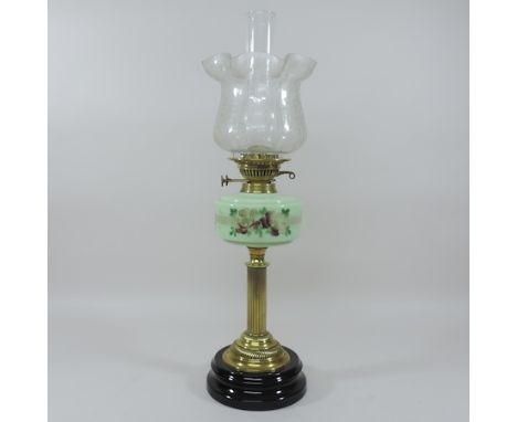 A 19th century brass oil lamp, with a green opaline reservoir and etched glass shade, 66cm tall overall