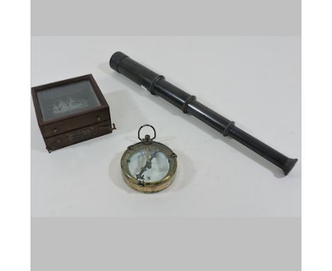 A reproduction map reader compass, in a fitted case, together with a small telescope