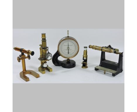 A Vernier microscope, 18cm tall, together with three others and a micrometer