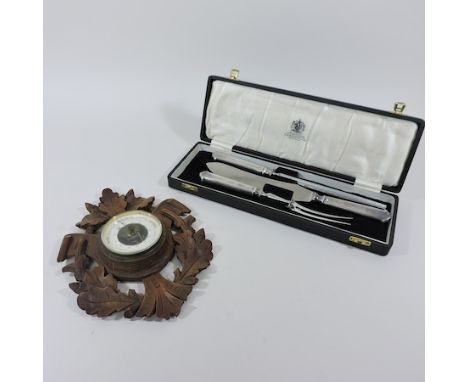An early 20th century aneroid barometer, 27cm tall, together with an Elkington carving set, cased