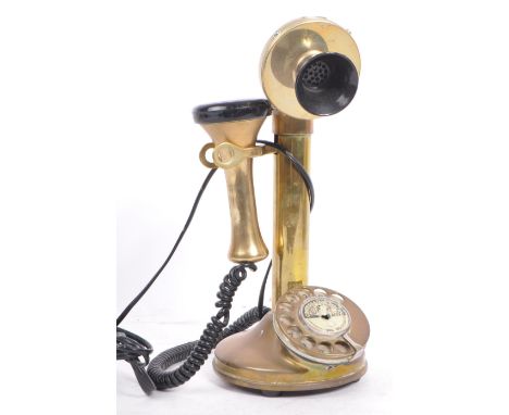 A 20th century vintage 'Conversation Pieces' brass and Bakelite candlestick telephone with chrome metal dial. Measures 30cm t