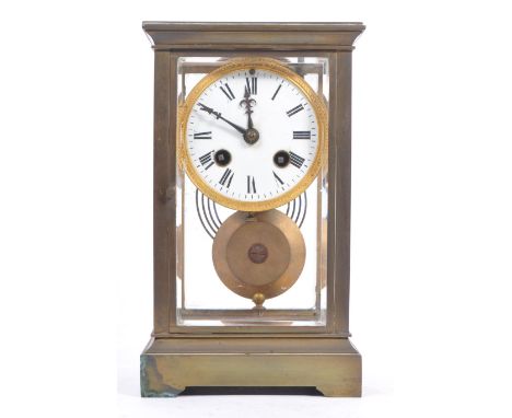 A French eight day movement brass four glass mantel clock. Of rectangular form with white enamelled face and ebonised Roman n