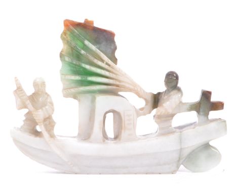 A 20th century carved Chinese Oriental green jade sailor / boat figurine. Measures approx. 9cm x 6.5cm (height).&nbsp;