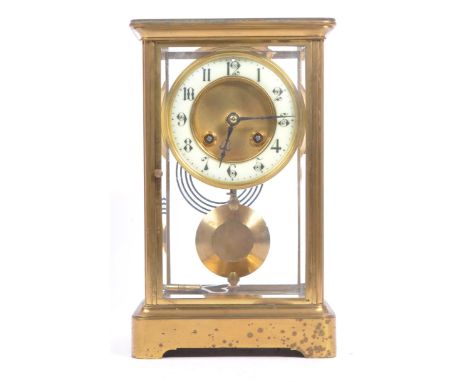 A French eight day movement brass four glass mantel clock. Rectangular form with enamelled face with ebonised chapter ring. W