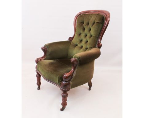 A Victorian walnut showframe armchair - upholstered in button-back green velour, scrolling arm supports, serpentine seat, rin