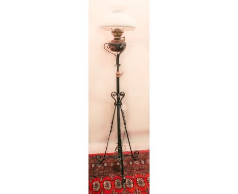 A black-painted wrought iron tripod standard lamp - converted from an oil lamp, 158cm high.