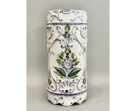 An Italian glazed stick-stand - with moulded shell and foliate scroll decorations, painted with purple, blue and yellow flowe