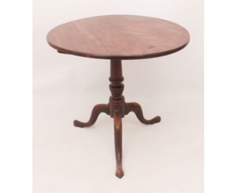 A George III mahogany circular tilt-top tripod table - the circular top on a turned and spiral-reeded column to three swept s