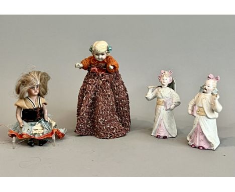 Two small early 20th century all-bisque dolls - one c.1910, with blonde wig, painted eyes, jointed arms and legs with stockin