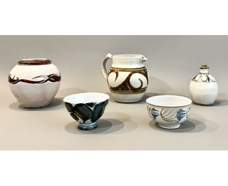 Five pieces of stoneware studio pottery - including a jug from Wenford Bridge Pottery, in an off-white glaze with olive green