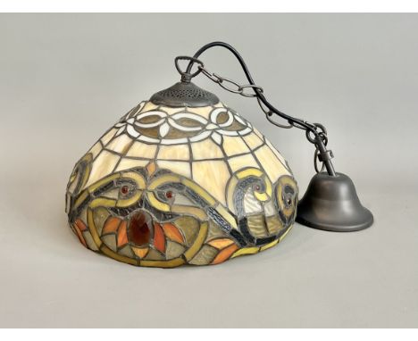 A Tiffany style leaded stained glass pendant lamp - the shade with shaped lower edge, with a design of stylised flowers and s