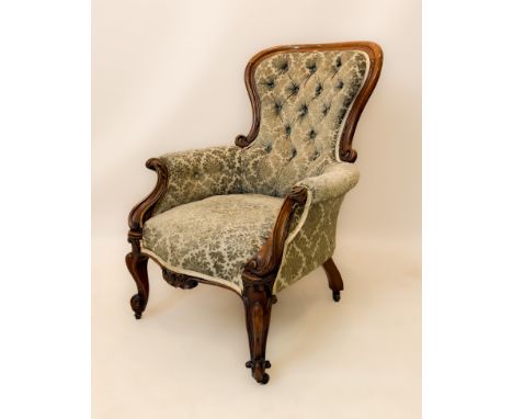 A Victorian carved walnut showframe armchair - with button back, in pale green velvet damask upholstery, raised on cabriole f
