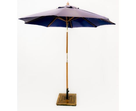 A folding garden parasol, navy fabric with patch repair - with a weighted square, slatted wood base, max. diameter 208cm, hei