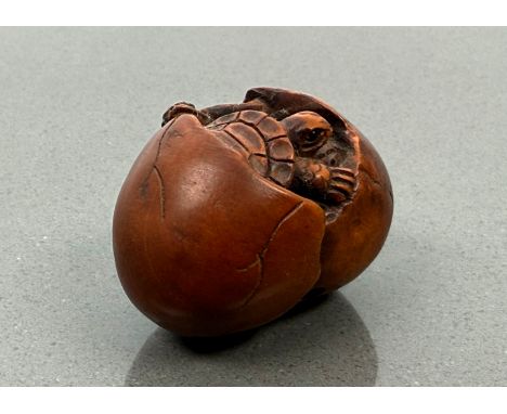 A Japanese carved boxwood netsuke - Meiji period (1868-1912), signed with single character mark, modelled as two baby turtles