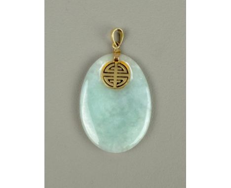 A gold-mounted oval jade pendant.