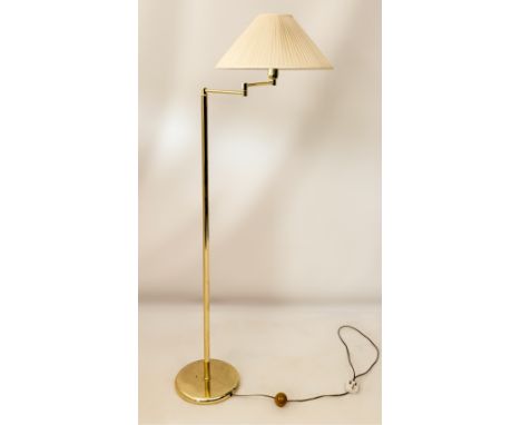 A brass standard reading lamp with adjustable arm - with ivory pleated silk shade, 157cm high.