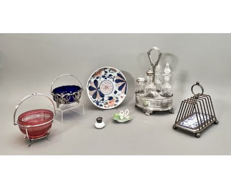 Seven pieces, comprising - 1. A silver plated and cut glass cruet stand, 27.5cm high;  2. A silver plated swing-handled sugar