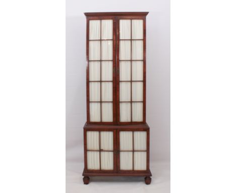 A George III style mahogany and walnut glazed bookcase - of tall and slender form, the upper structure with four removable sh