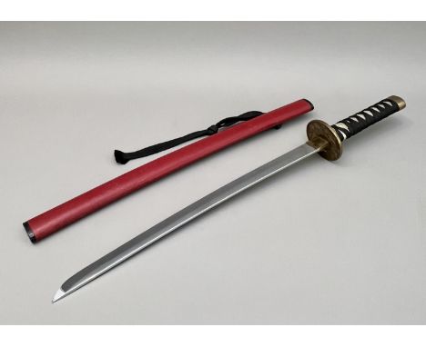 A modern replica of a Japanese katana (short sword) - blunt single edged blade, faux-shagreen cord-wrapped grip, brass-plated