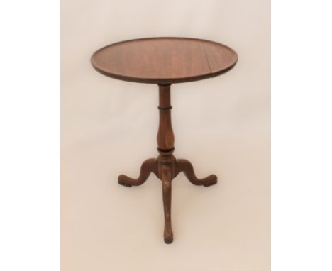 A 19th century mahogany tripod table - the dished, circular top on a turned baluster column to three swept legs with pad feet