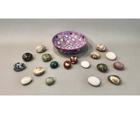 A ceramic bowl containing stone eggs - including examples in malachite, onyx, agate etc, the largest 6.9cm long; together wit