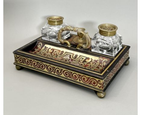 A Regency period 19th century ebony, red tortoiseshell and brass Boulle style desk stand - with central foliate brass handle,