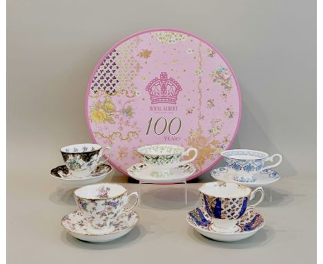 A Royal Albert '100 Years' set of cups and saucers - comprising three duos in a different pattern from different decades from